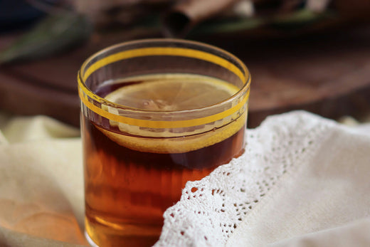 A steaming cup of Lemon Ginger Detox Tea, with fresh lemon slices and a hint of ginger, offering a soothing and refreshing detoxifying beverage.